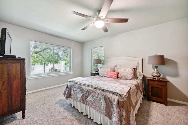 4722 Frontier Trl, Austin, TX 78745 - bedroom with baseboards, light colored carpet, and ceiling fan