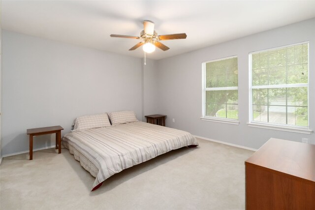 3817 E Newland Dr, Round Rock, TX 78681 - bedroom featuring light carpet, multiple windows, ceiling fan, and baseboards