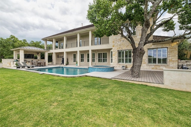 4101 Top Of Texas Trl, Austin, TX 78735 - back of property featuring stone siding, a lawn, a balcony, a patio, and a pool with connected hot tub