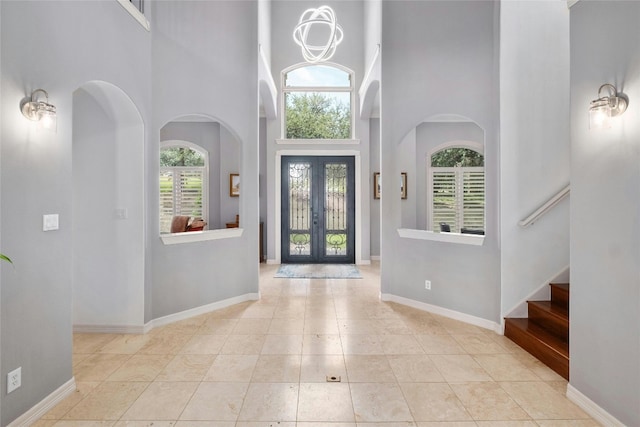 4101 Top Of Texas Trl, Austin, TX 78735 - foyer entrance featuring plenty of natural light, a high ceiling, tile patterned floors, stairway, and french doors