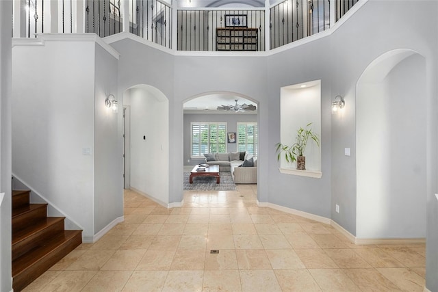 4101 Top Of Texas Trl, Austin, TX 78735 - foyer entrance featuring arched walkways, stairway, ceiling fan, and a towering ceiling