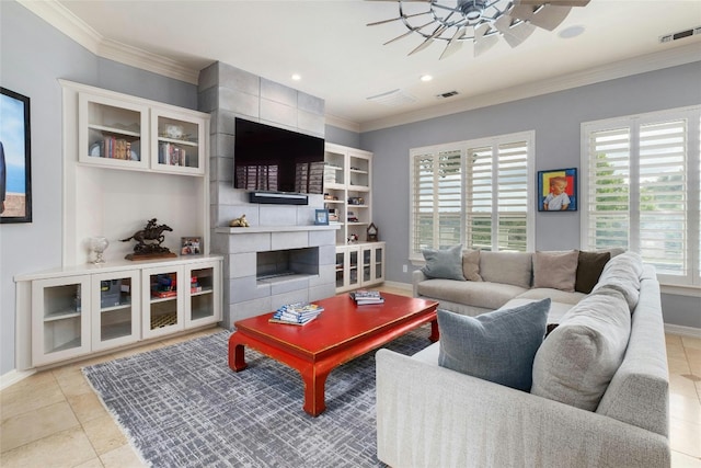 4101 Top Of Texas Trl, Austin, TX 78735 - living area with ornamental molding, a tiled fireplace, a ceiling fan, recessed lighting, and light tile patterned floors