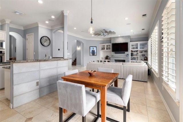 4101 Top Of Texas Trl, Austin, TX 78735 - dining area featuring arched walkways, light tile patterned floors, crown molding, recessed lighting, and a ceiling fan