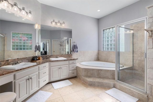 4101 Top Of Texas Trl, Austin, TX 78735 - full bath featuring double vanity, a garden tub, a stall shower, and tile patterned flooring