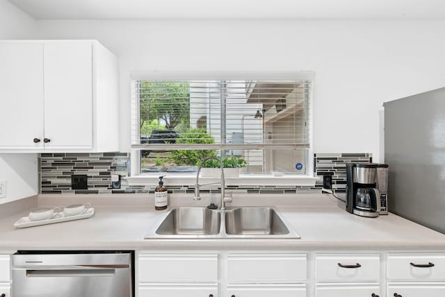10701 Garbacz Dr, Austin, TX 78748 - kitchen with dishwasher, a sink, decorative backsplash, light countertops, and white cabinetry