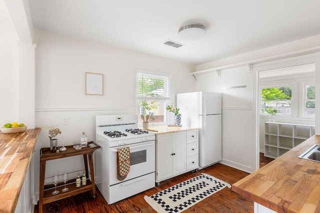 1200 Cullen Ave Unit B, Austin, TX 78757 - kitchen featuring butcher block countertops, white appliances, white cabinets, dark wood-style flooring, and visible vents