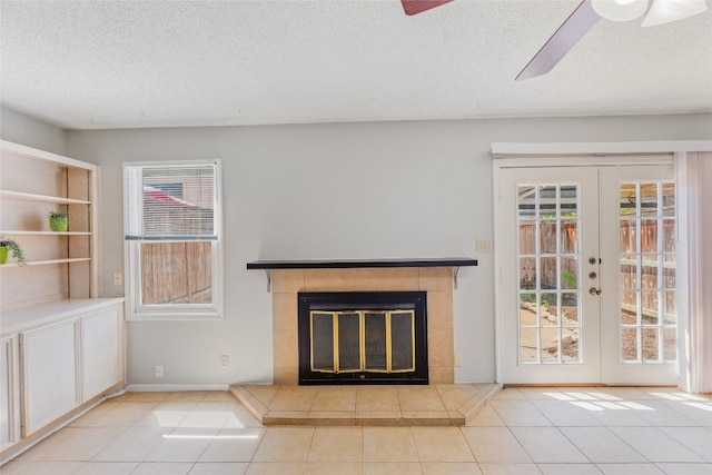 unfurnished living room featuring plenty of natural light, tile patterned flooring, and ceiling fan