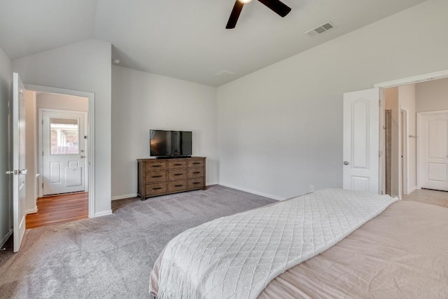 carpeted bedroom with lofted ceiling, baseboards, a ceiling fan, and visible vents
