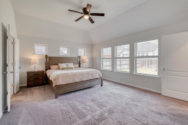 carpeted bedroom with lofted ceiling, a ceiling fan, and baseboards