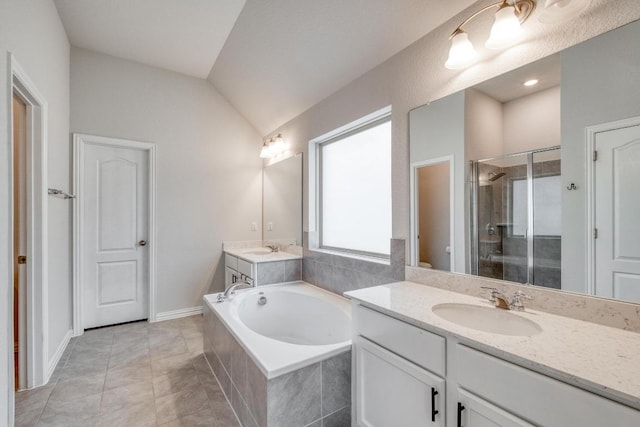full bath featuring a garden tub, a stall shower, vanity, lofted ceiling, and tile patterned flooring