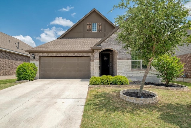 view of front facade with a front lawn, driveway, a garage, brick siding, and roof with shingles