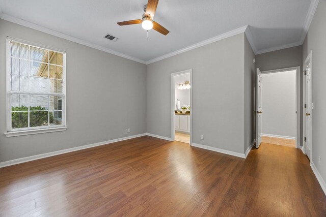 1107 Saint John Ct, Pflugerville, TX 78660 - spare room with crown molding, a ceiling fan, visible vents, baseboards, and wood finished floors