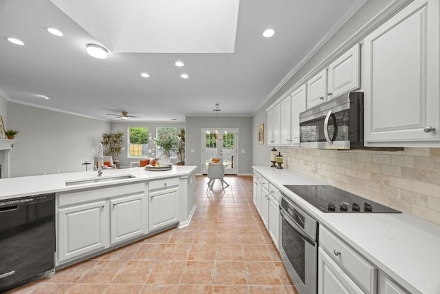 1107 Saint John Ct, Pflugerville, TX 78660 - kitchen with recessed lighting, black appliances, crown molding, and a sink