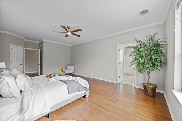 1107 Saint John Ct, Pflugerville, TX 78660 - bedroom with crown molding, visible vents, baseboards, wood finished floors, and ensuite bath