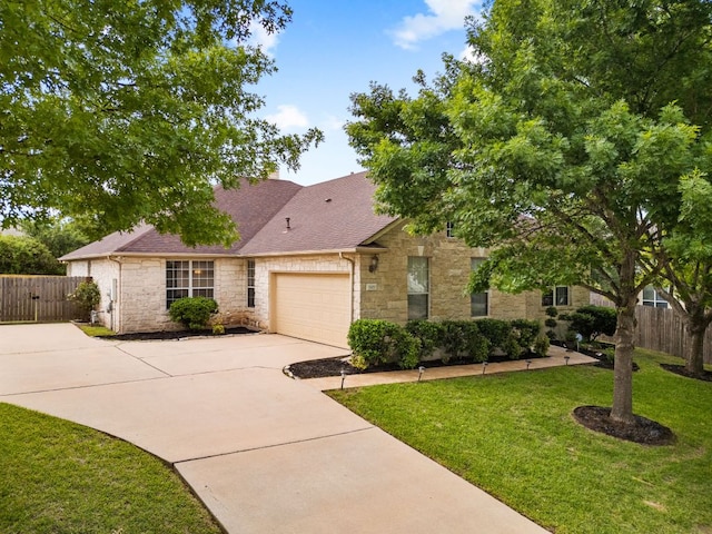 1107 Saint John Ct, Pflugerville, TX 78660 - view of front of home with a front lawn, stone siding, concrete driveway, an attached garage, and a shingled roof