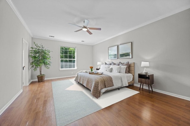 1107 Saint John Ct, Pflugerville, TX 78660 - bedroom featuring wood finished floors, a ceiling fan, ornamental molding, and baseboards