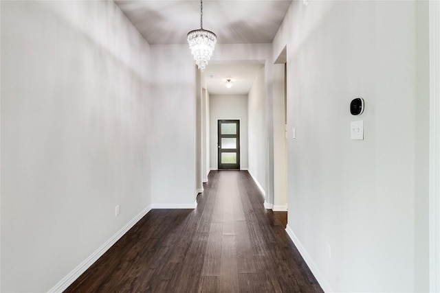 22621 Fountaingrass Ln, Lago Vista, TX 78645 - hallway featuring baseboards, a chandelier, and dark wood-type flooring
