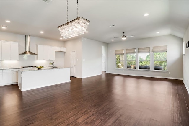 22621 Fountaingrass Ln, Lago Vista, TX 78645 - unfurnished living room featuring dark wood-style floors, recessed lighting, ceiling fan, and a sink