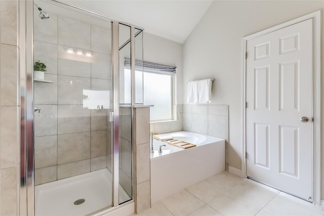 22621 Fountaingrass Ln, Lago Vista, TX 78645 - bathroom featuring tile patterned floors, a garden tub, a shower stall, and lofted ceiling
