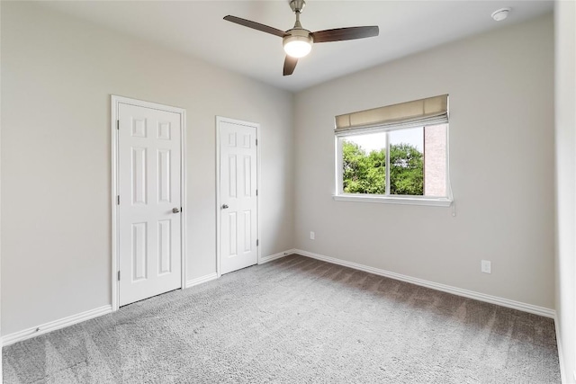 22621 Fountaingrass Ln, Lago Vista, TX 78645 - unfurnished bedroom with baseboards, carpet, and multiple closets