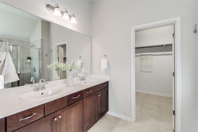 22621 Fountaingrass Ln, Lago Vista, TX 78645 - full bathroom featuring baseboards, a stall shower, double vanity, and a sink