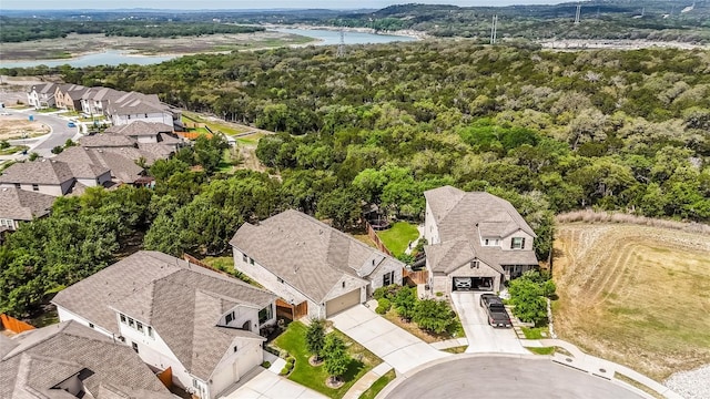 22621 Fountaingrass Ln, Lago Vista, TX 78645 - drone / aerial view featuring a residential view, a water view, and a wooded view
