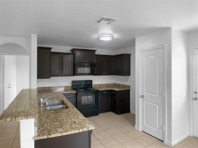 115 Millers Loop, Jarrell, TX 76537 - kitchen with visible vents, light tile patterned floors, a sink, black appliances, and a peninsula