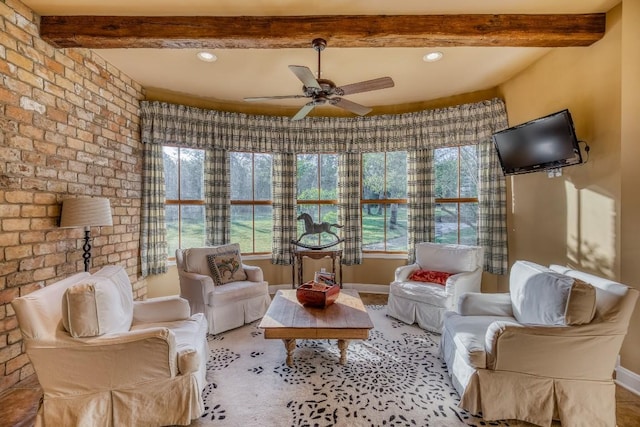 interior space with beamed ceiling and a wealth of natural light