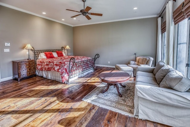 bedroom featuring recessed lighting, wood finished floors, crown molding, and baseboards