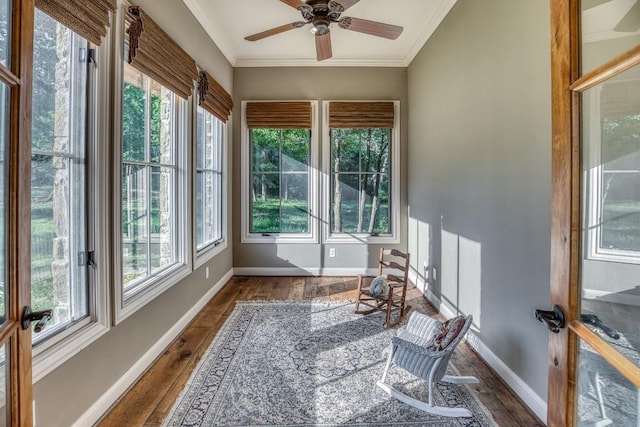 sunroom with baseboards, ornamental molding, and wood finished floors