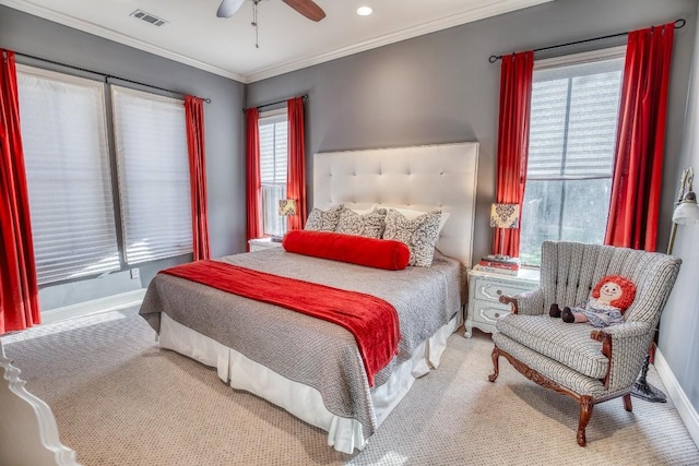 bedroom with visible vents, a ceiling fan, ornamental molding, baseboards, and carpet flooring