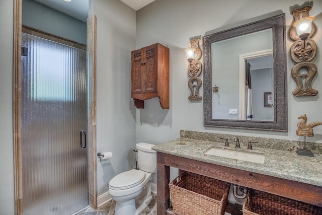 full bathroom with a shower stall, vanity, toilet, and baseboards