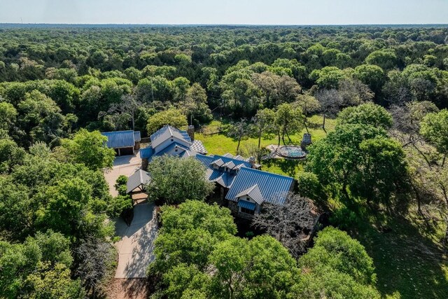 bird's eye view with a wooded view