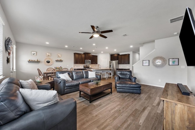 337 Akumal St, Leander, TX 78641 - living room featuring a ceiling fan, wood finished floors, and recessed lighting