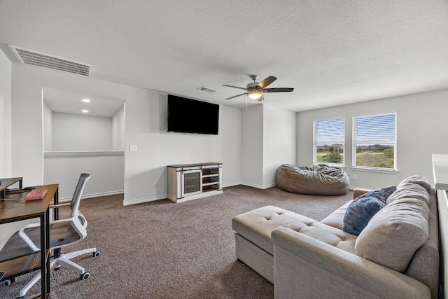337 Akumal St, Leander, TX 78641 - carpeted living room featuring a ceiling fan, an office area, baseboards, and a textured ceiling