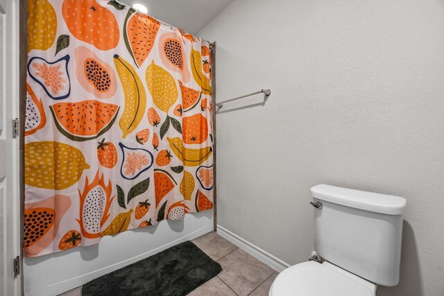 337 Akumal St, Leander, TX 78641 - bathroom featuring toilet, tile patterned flooring, shower / bathtub combination with curtain, and baseboards
