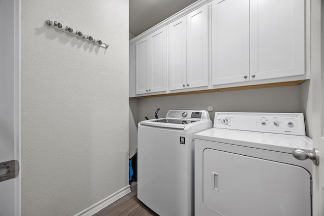 337 Akumal St, Leander, TX 78641 - laundry area with washer and clothes dryer, cabinet space, baseboards, and dark wood-style flooring