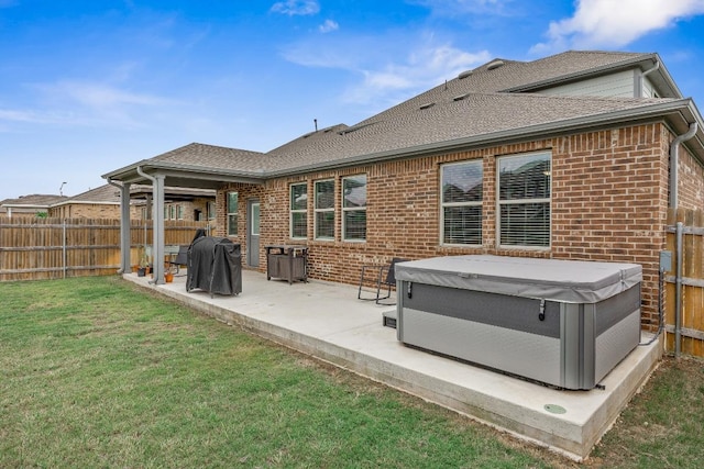 337 Akumal St, Leander, TX 78641 - rear view of property with a hot tub, brick siding, a patio area, and a shingled roof