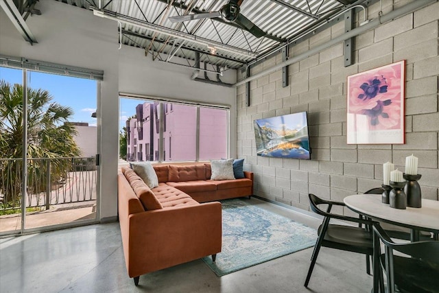 4801 S Congress Ave Unit D6, Austin, TX 78745 - living room featuring concrete block wall and concrete flooring