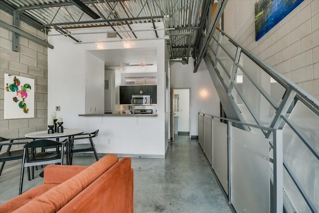 4801 S Congress Ave Unit D6, Austin, TX 78745 - living room with finished concrete floors and a towering ceiling