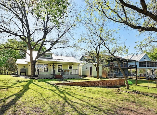 1318 Contour Dr, Burnet, TX 78611 - back of house with a porch, a lawn, and a metal roof