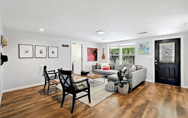 living area featuring baseboards, wood finished floors, visible vents, and recessed lighting