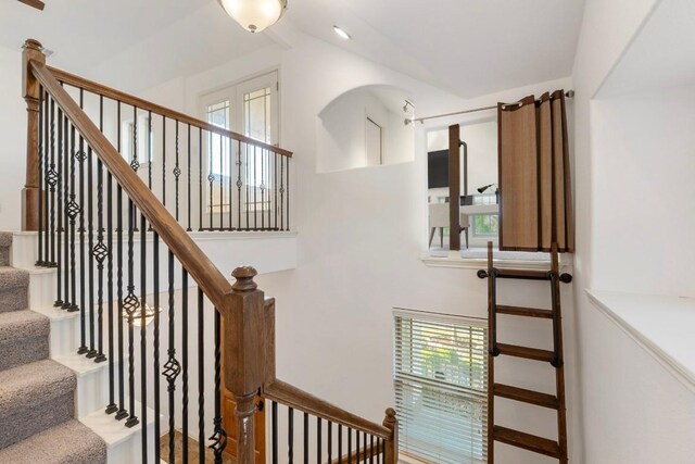 staircase with lofted ceiling