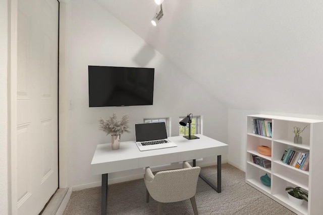 carpeted office featuring lofted ceiling, baseboards, and built in features