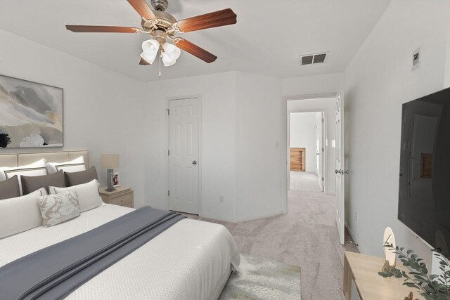bedroom featuring visible vents, a ceiling fan, and carpet floors