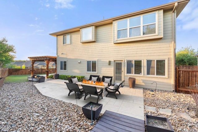 rear view of property featuring a pergola, a fenced backyard, and a patio