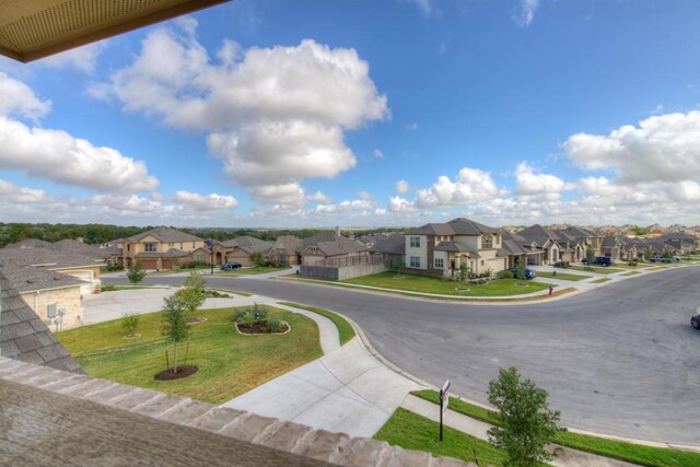 view of street featuring curbs, sidewalks, and a residential view