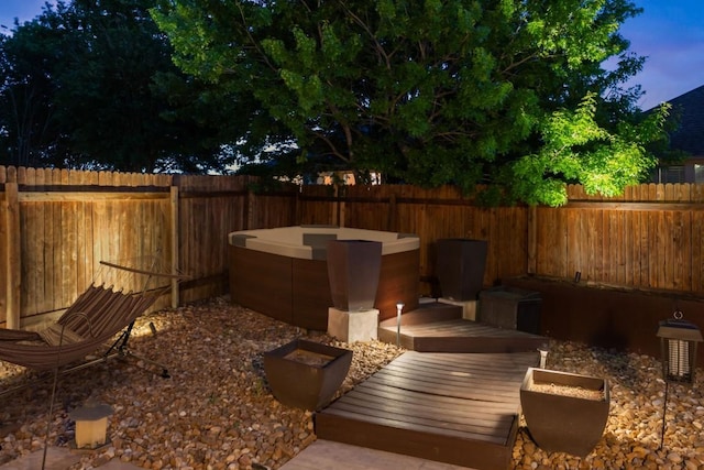 view of yard with a fenced backyard and a hot tub