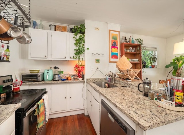 kitchen featuring a toaster, a sink, dark wood-type flooring, appliances with stainless steel finishes, and white cabinetry