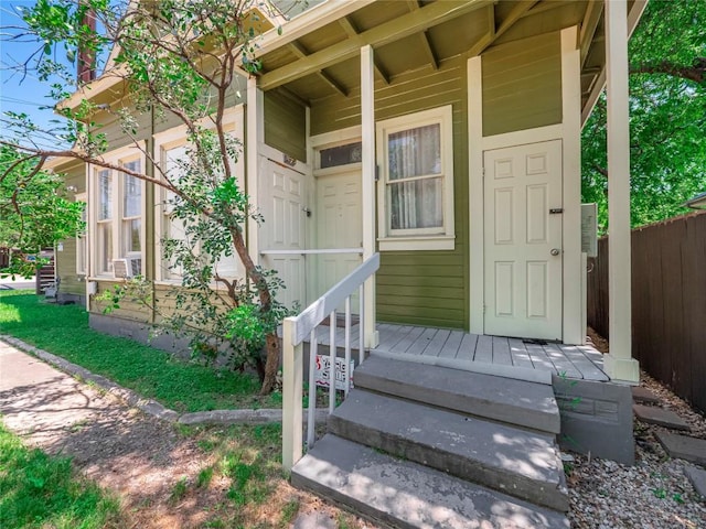 entrance to property featuring fence